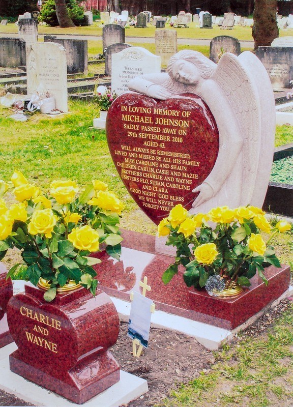 Red heart memorial with floral tribute